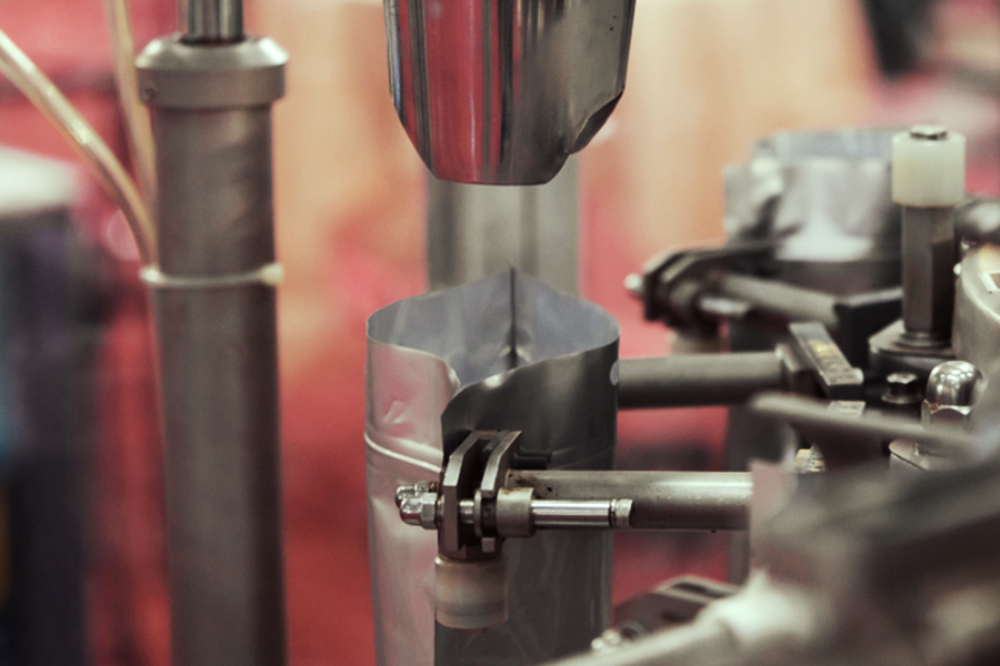 Bulk powder package being filled on an assembly line