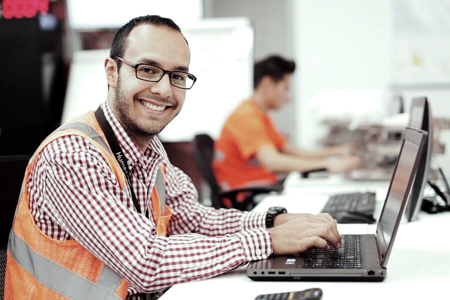 employee at desk with a laptop