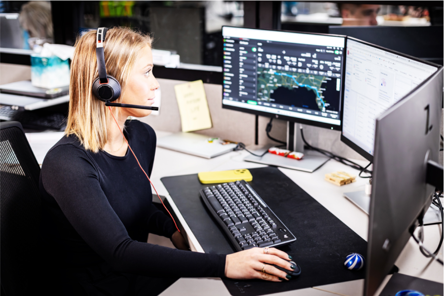 woman on computer helping to manage transportation networks