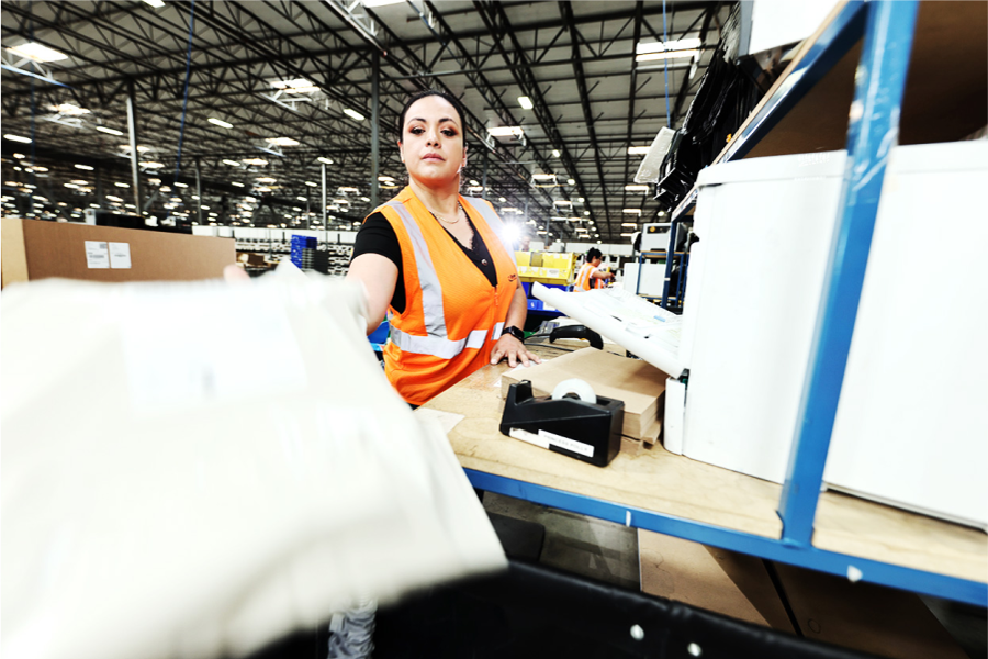 warehouse worker handing off package