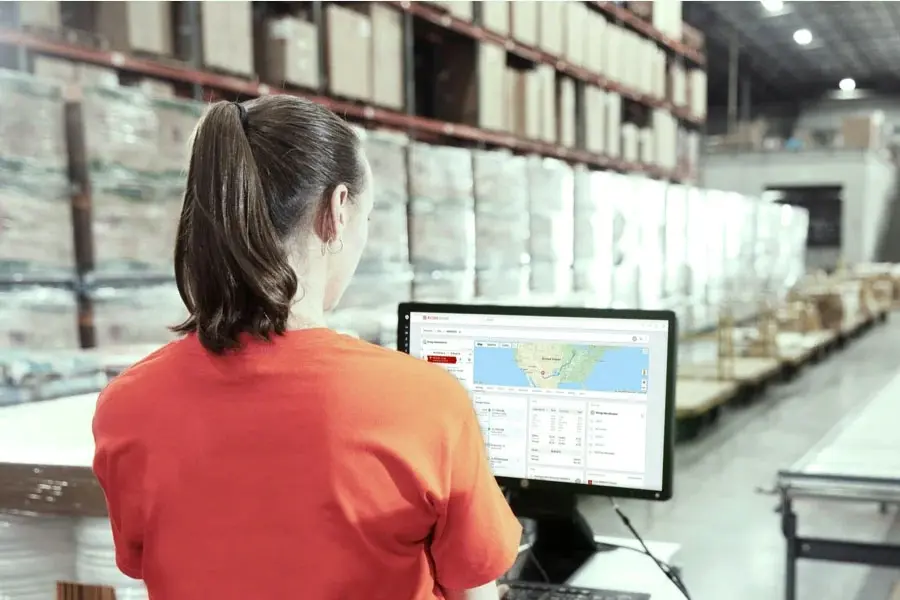 woman in warehouse at computer